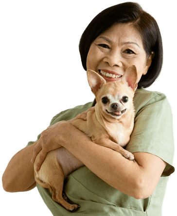 Smiling woman holding her chihuahua